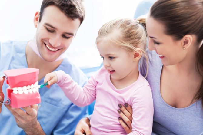 When to take the child for first oral examination?